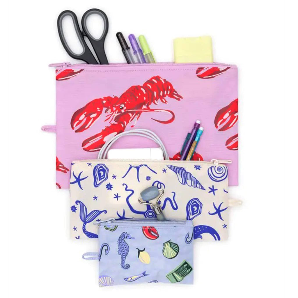Baggu Sea Creatures recycled heavyweight nylon flat zipper pouch, set of 3 in different sizes and designs, with offices supplies, chargers and beauty supplies.