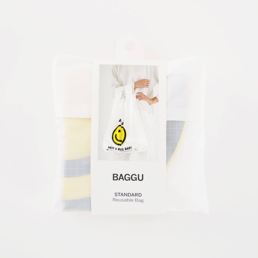 Baggu reusable standard white ripstop nylon bag in thank you happy folded into pouch with belly band packaging.