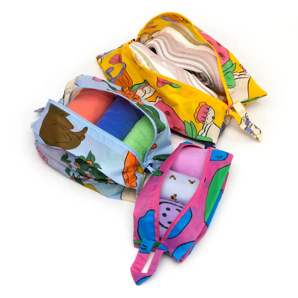 Baggu reusable recycled ripstop nylon 3D zip bags, set of 3 in Still Life prints, open and filled with shoes, socks and garments.