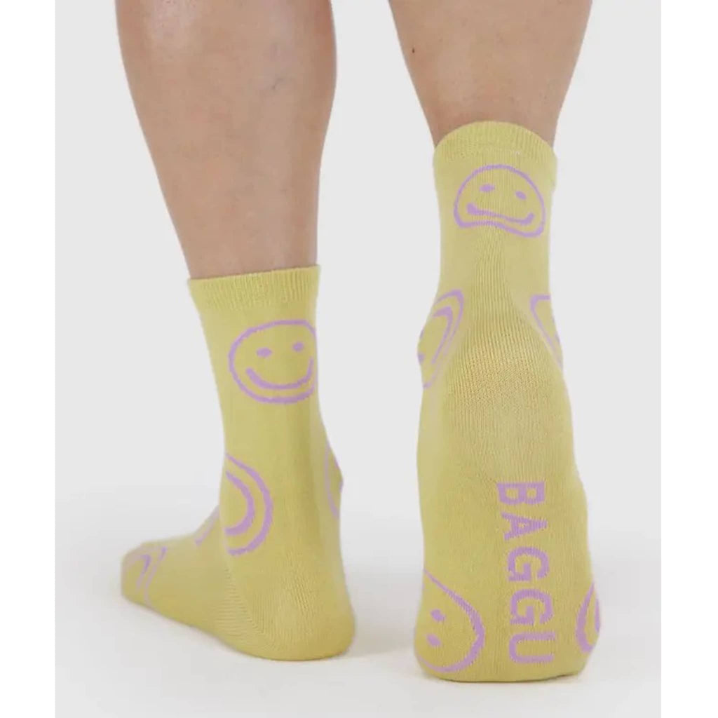 Baggu Straw Happy bamboo rayon unisex crew socks, on model, back view.