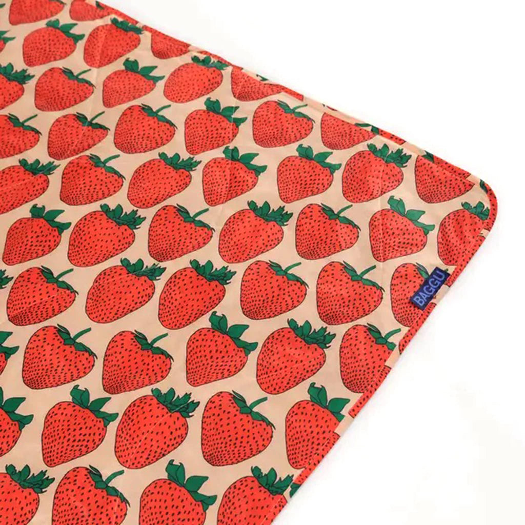 Baggu Strawberry puffy recycled ripstop nylon and polyester picnic blanket, detail of corner.