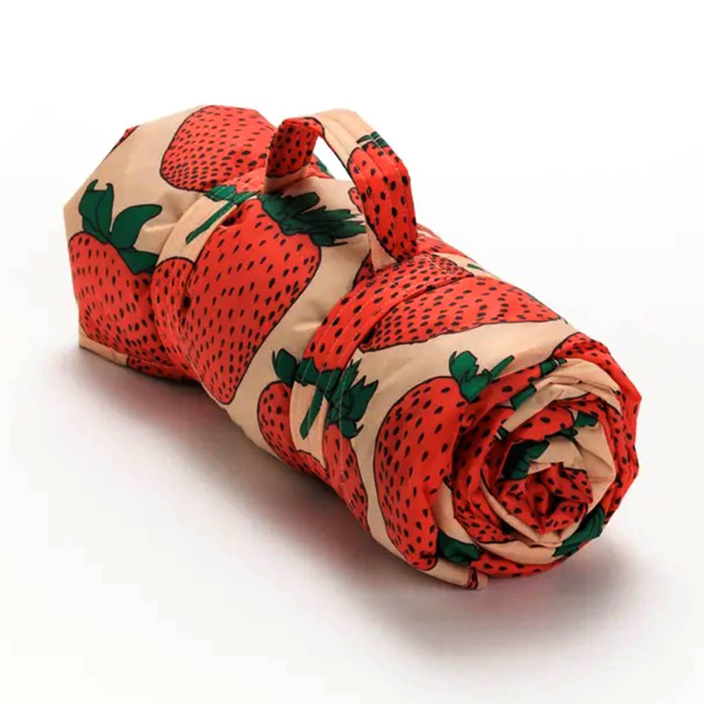 Baggu Strawberry puffy recycled ripstop nylon and polyester picnic blanket, rolled up.