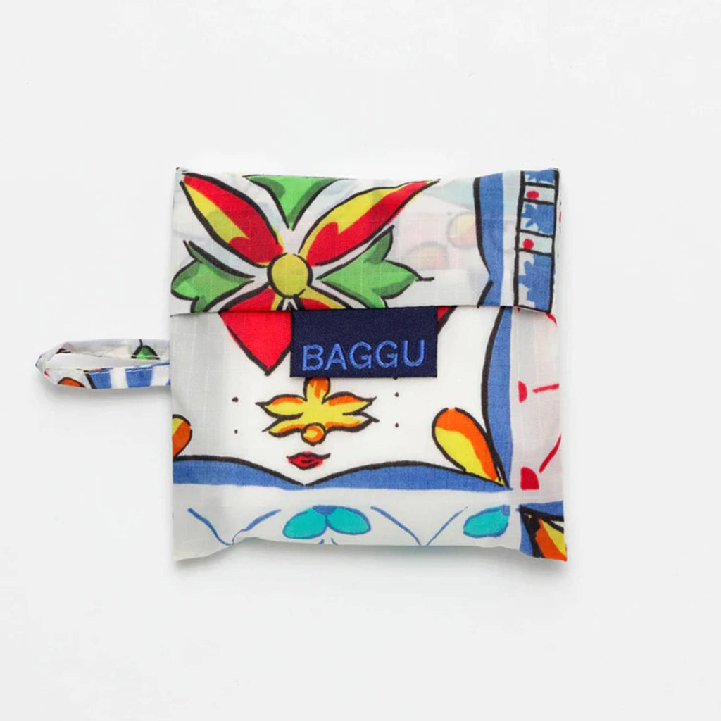 Baggu baby size eco-friendly recycled ripstop nylon reusable tote bag with Sunshine Tile pattern, in matching pouch.