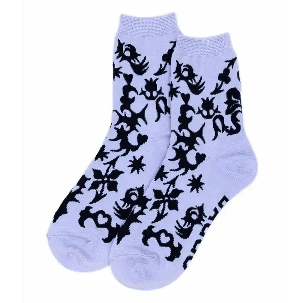 Light purple socks with black abstract pattern on a white background.
