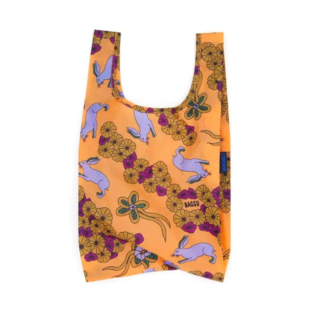 Reusable bag with rabbit and floral pattern on an orange background.