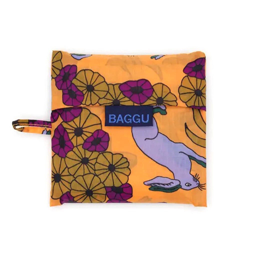 Floral-patterned reusable bag with 'BAGGU' branding on an orange background