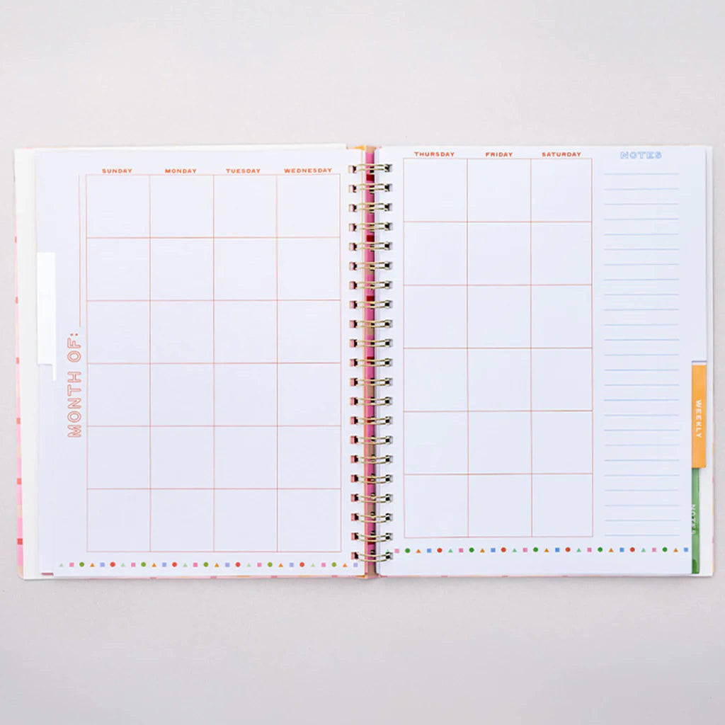 Open planner with undated month layout on a white background.