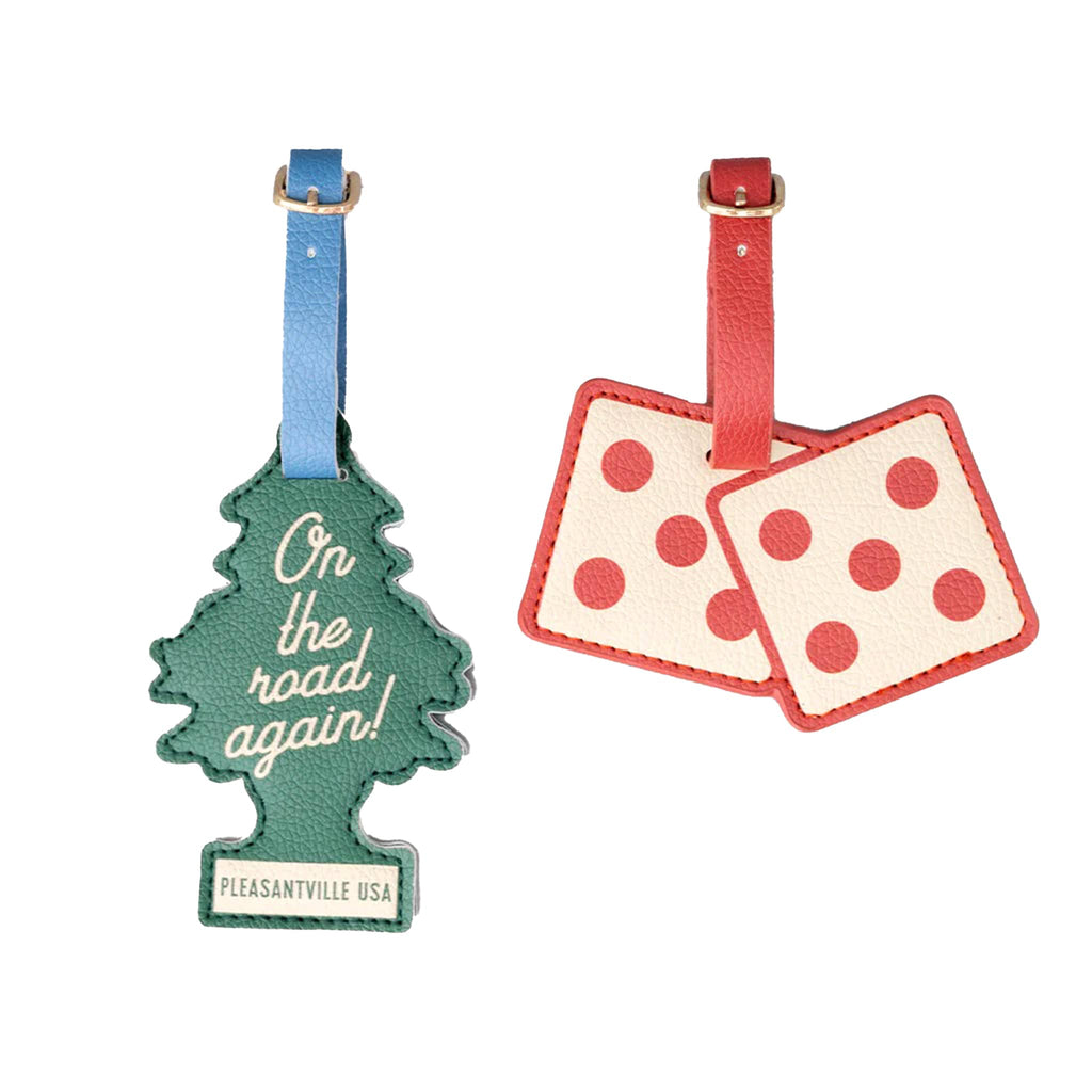 Two luggage tags, one tree-shaped green with 'on the road again!' and one dice-shaped white with red polka dots, on a white background.