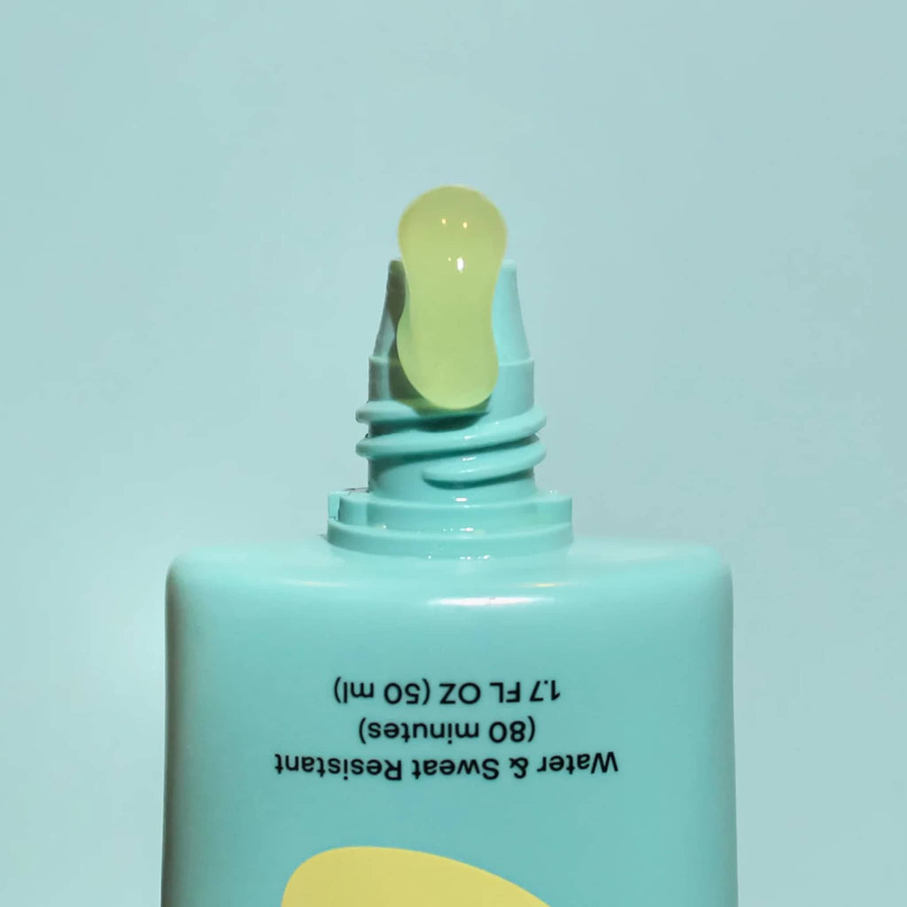 Bask 40 SPF Daily Invisible Gel broad-spectrum sunscreen in blue tube with product squeezing out of the top.