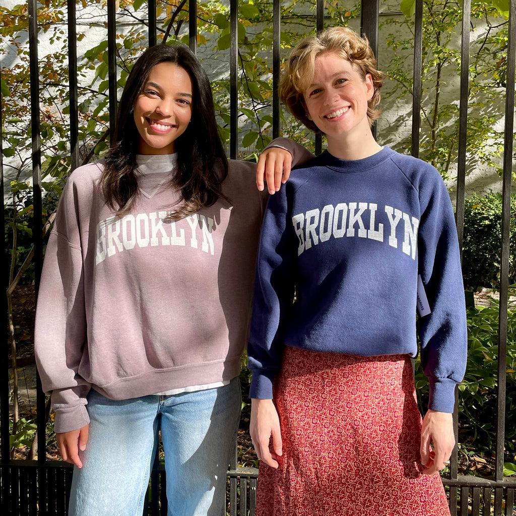 Best Regards vintage Brooklyn Varsity upcycled sweatshirt in dusty pink and royal blue, shown on models.