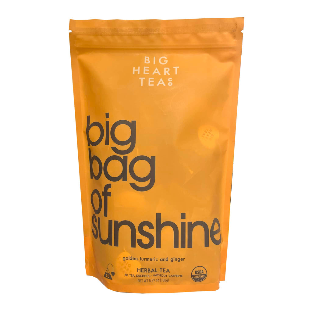 Big Heart Co. Big Bag of Sunshine Golden Turmeric and Ginger herbal tea, pack of 50 sachets in orange pouch packaging, front view.