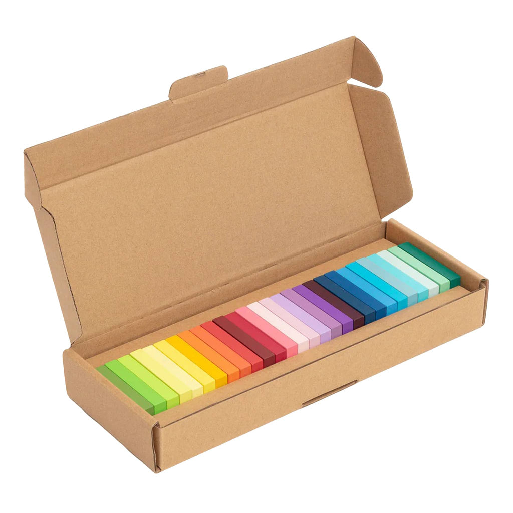 Set of colorful wooden dominoes in a cardboard box on a white background.