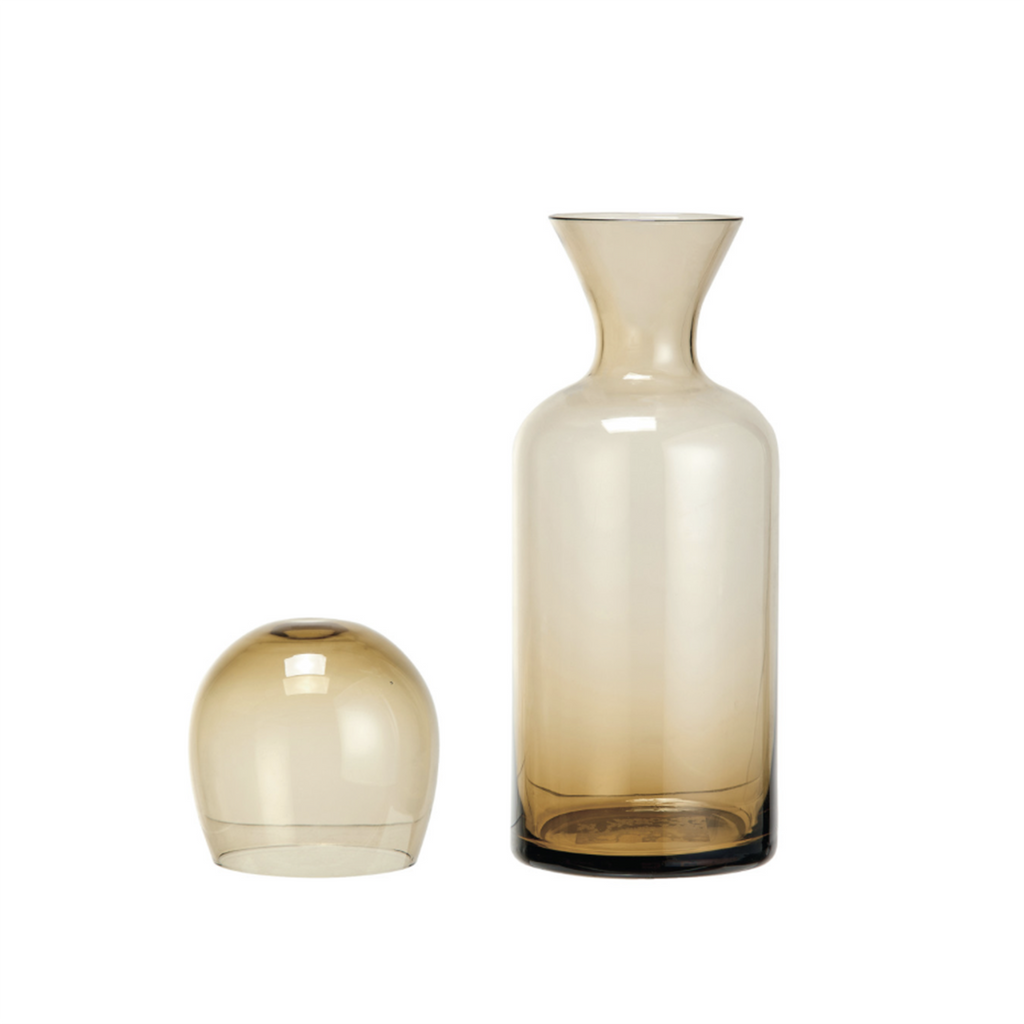 Bloomingville 16 oz glass carafe with 12 oz drinking glass amber beside it and upside down.