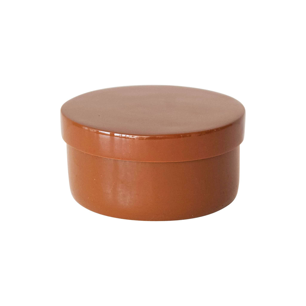 Round caramel brown lacquered container with lid on a white background.