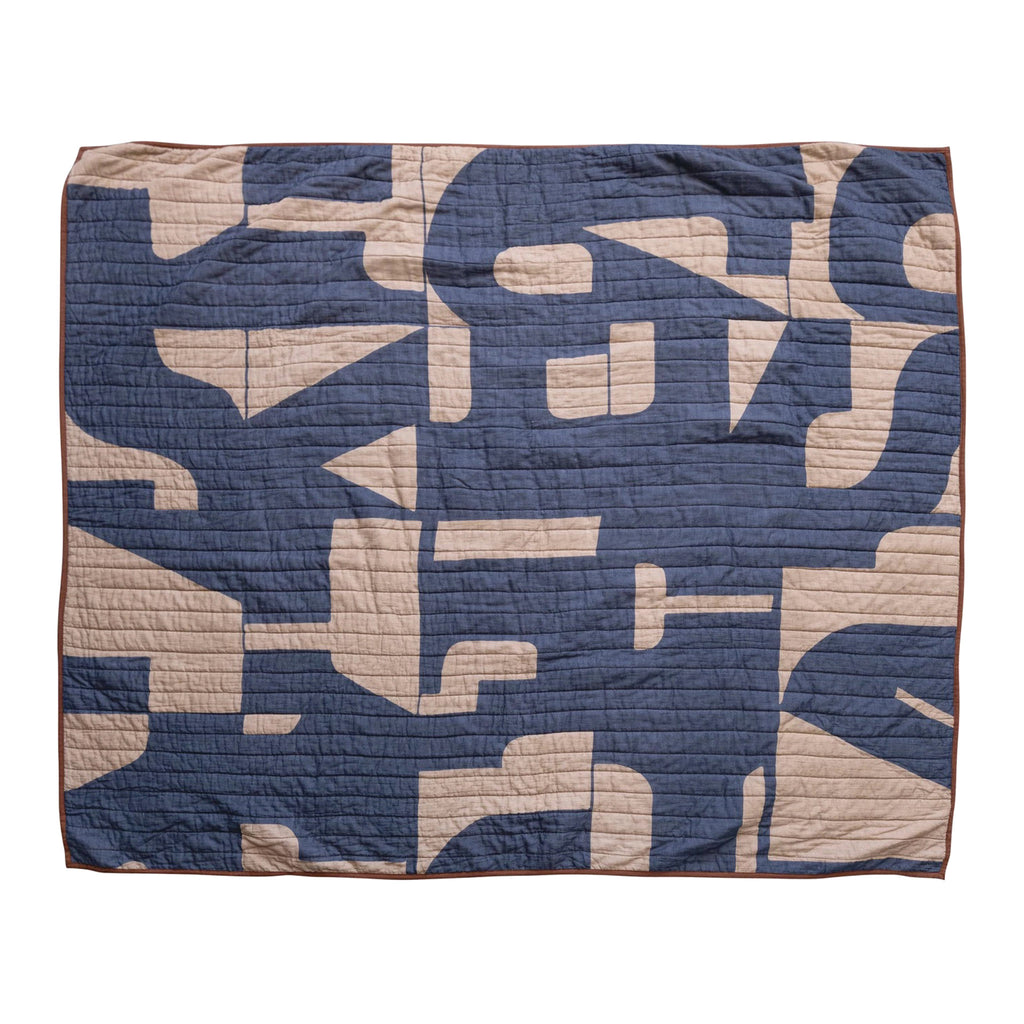 Bloomingville blue and beige quilted cotton throw blanket with abstract pattern and brown trim, front view.