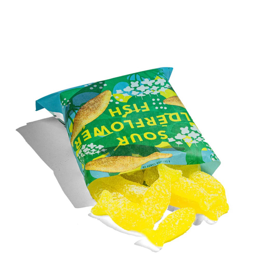 BonBon NYC Sour Elderflower Fish swedish gummy candy in blue packaging, sour sugar-coated yellow fish candies spilling out of open package.