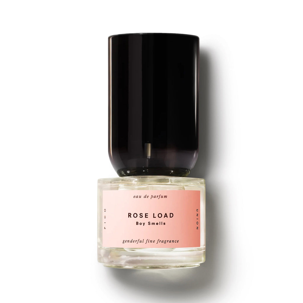 Boy Smells Rose Load Eau de Parfum in bottle with pink label and shaped black cap.