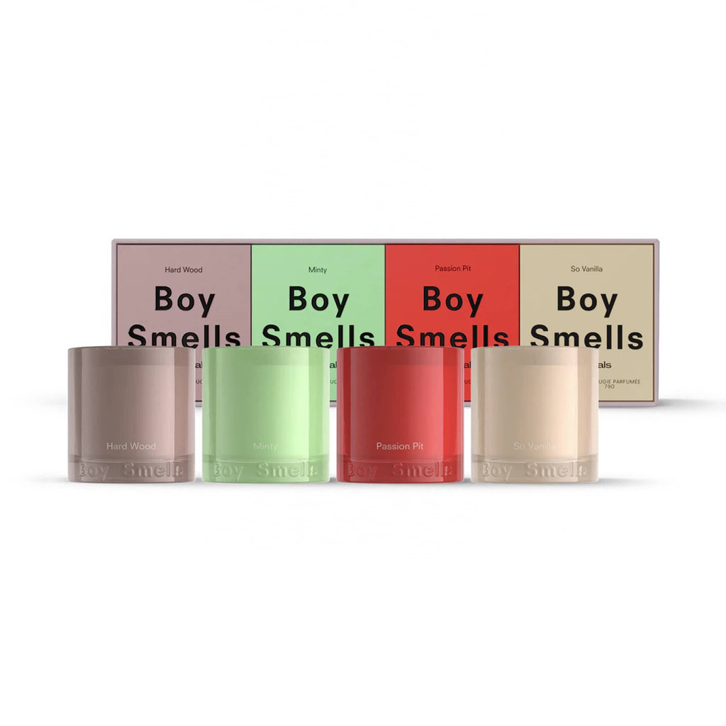 Set of four votive candles in different colors with 'Boy Smells' branding and boxes behind, on a white background.
