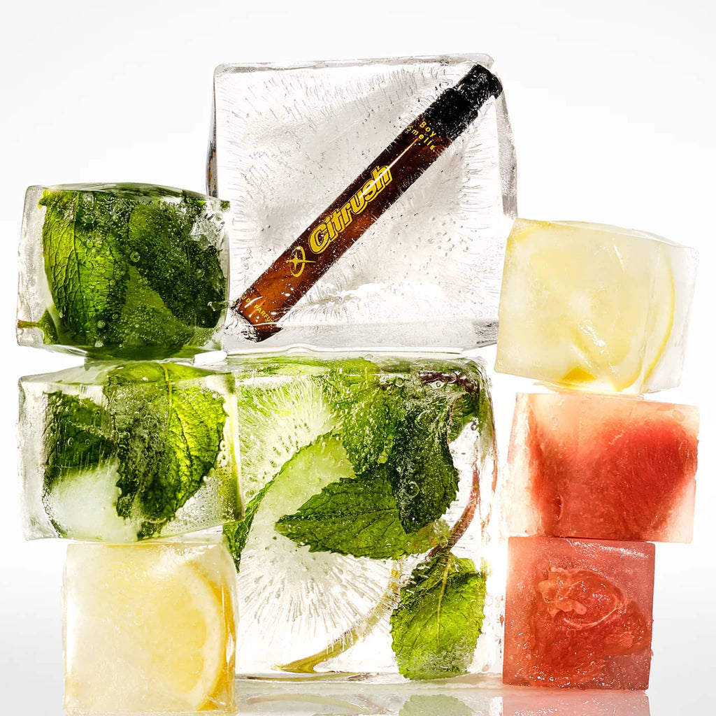 Boy Smells Citrush scented eau de parfum travel spray bottle, frozen in ice with grapefruit, lemon slices and mint leaves.