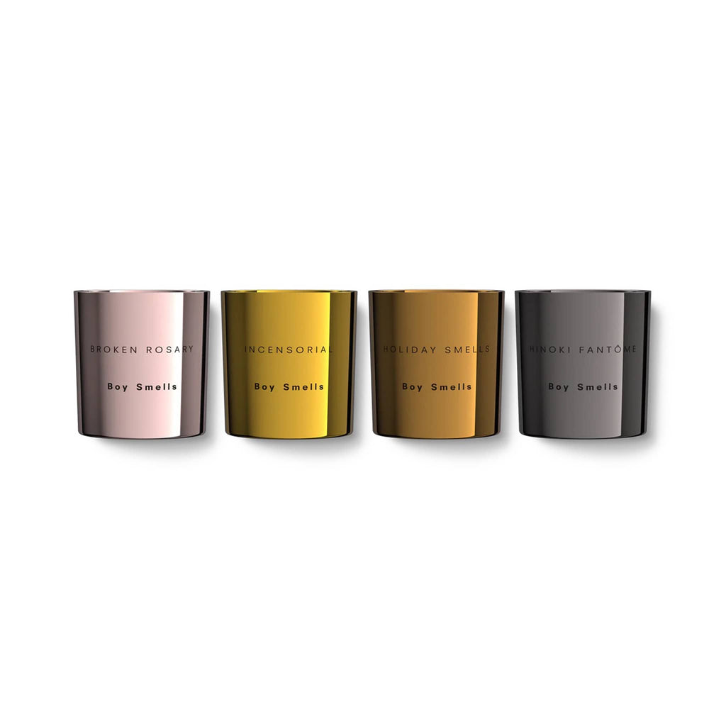 Boy Smells 2024 Limited Edition Holiday Votive Set of four scents in pink, gold, bronze and dark silver metallic glass tumblers with candle name and "boy smells" engraved on the front.