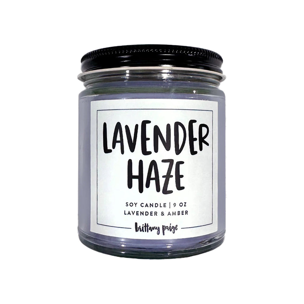 Brittany Paige Lavender Haze Lavender and Amber scented soy wax candle in clear glass jar with a black lid and white label.