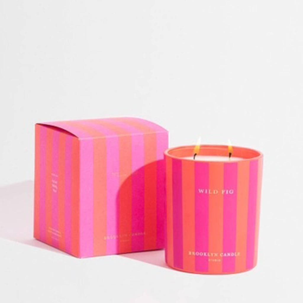 Pink and orange striped candle and packaging on a light gray background.