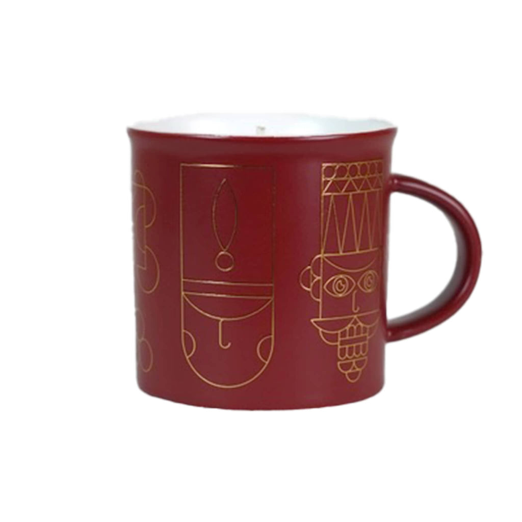 Red mug with gold nutcracker soldier designs on a white background.