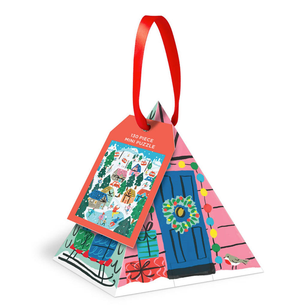 Chronicle Galison 130 piece Alpine Cottage mini jigsaw puzzle ornament in pyramid box packaging with red ribbon loop.