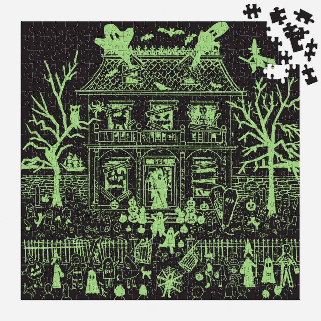 Halloween-themed puzzle glowing in the dark on a white background.