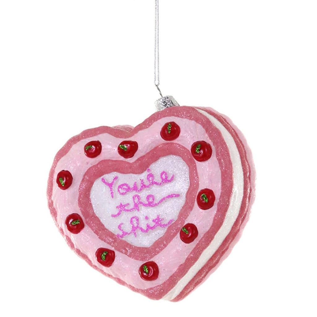 Heart-shaped pink cake ornament with red berries and 'You're the shit' text on a white background.
