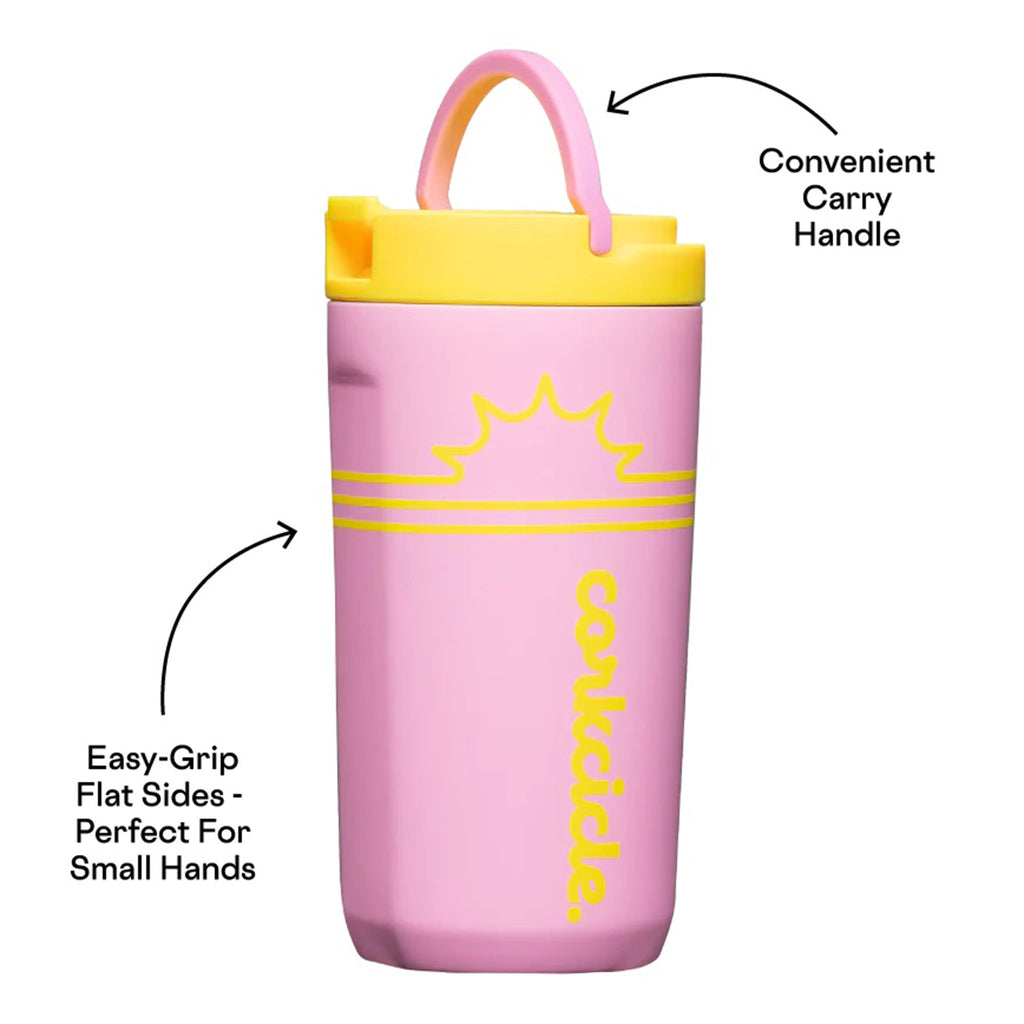 Corkcicle Sunny Pink 12 ounce Insulated Stainless Steel Kids Cup in pink with yellow lid, sun graphic and corkcicle script logo, front view with carry handle up.