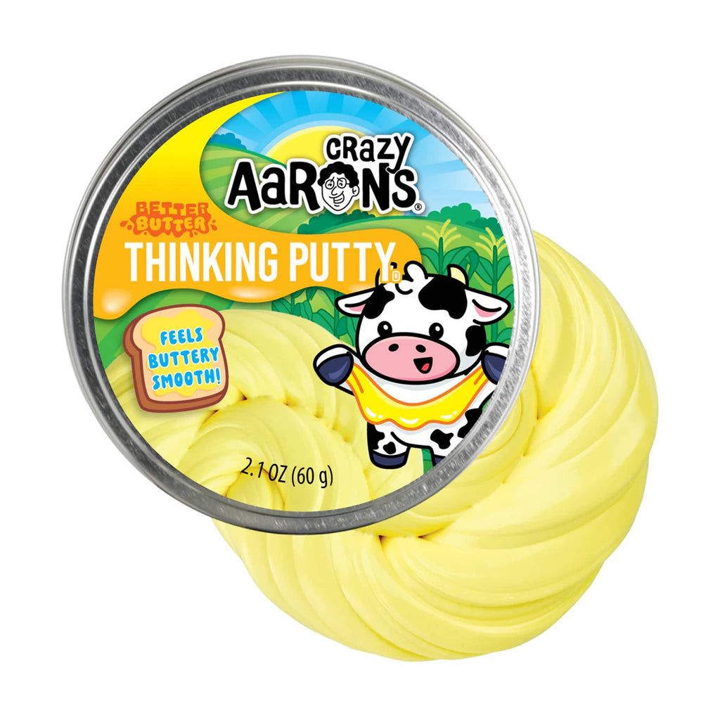 Crazy Aaron's Better Butter Thinking Putty tin with a cartoon cow character and a swirl of yellow putty behind it, on a white background.