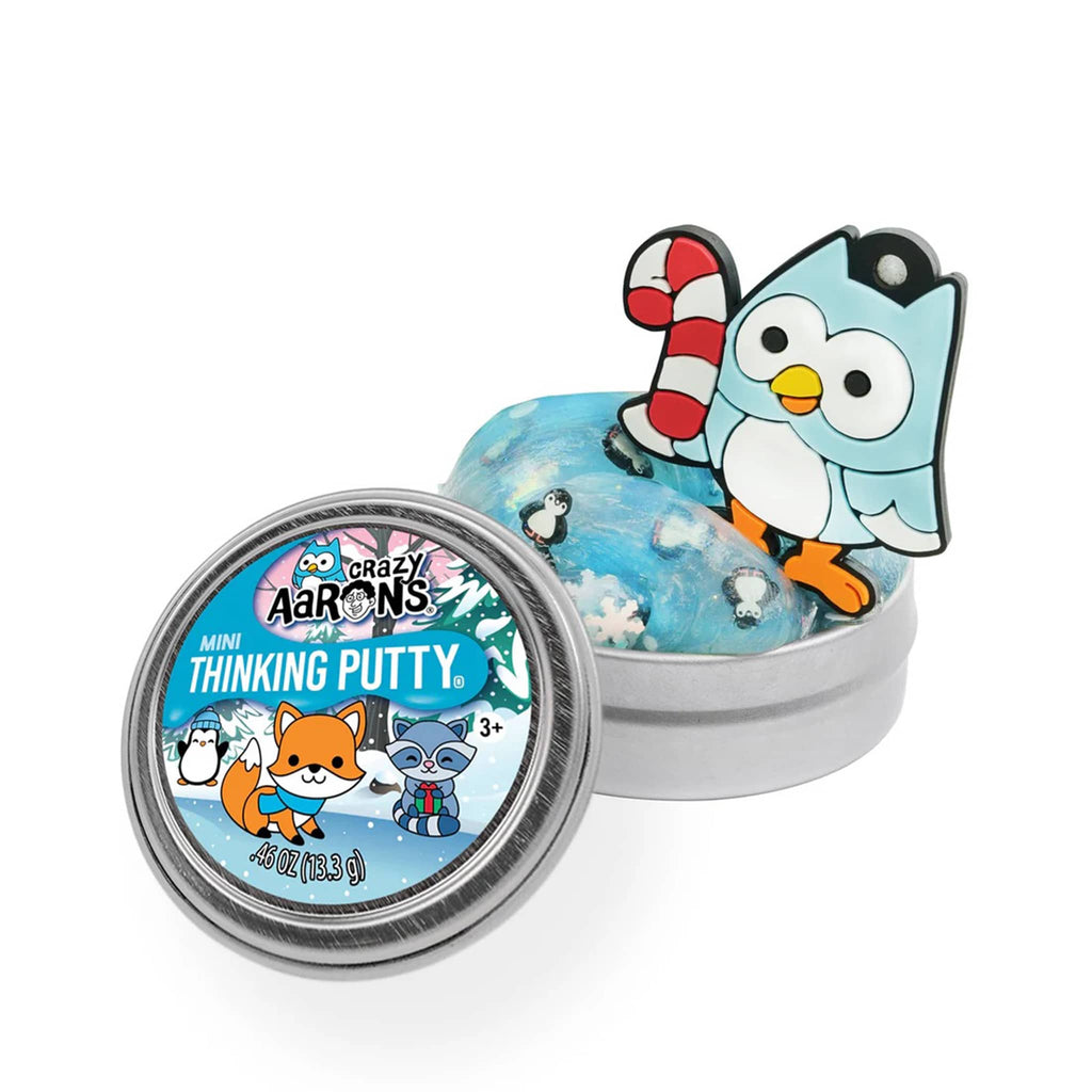 Crazy Aaron's Thinking Putty with penguin and snowflake mix-ins and a bird charm, on a white background.