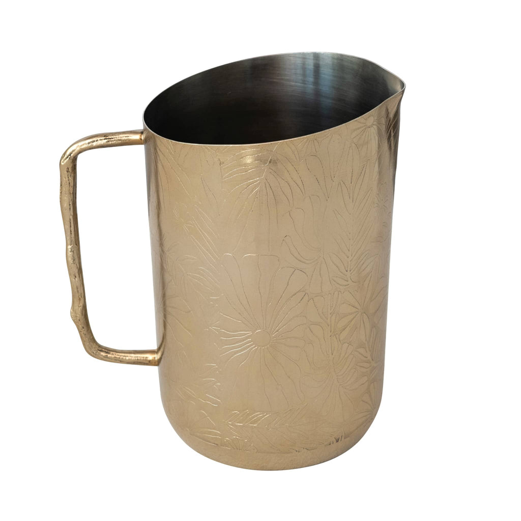 Creative Co-op Stainless Steel Pitcher with floral etched pattern and brass twig handle on the left.