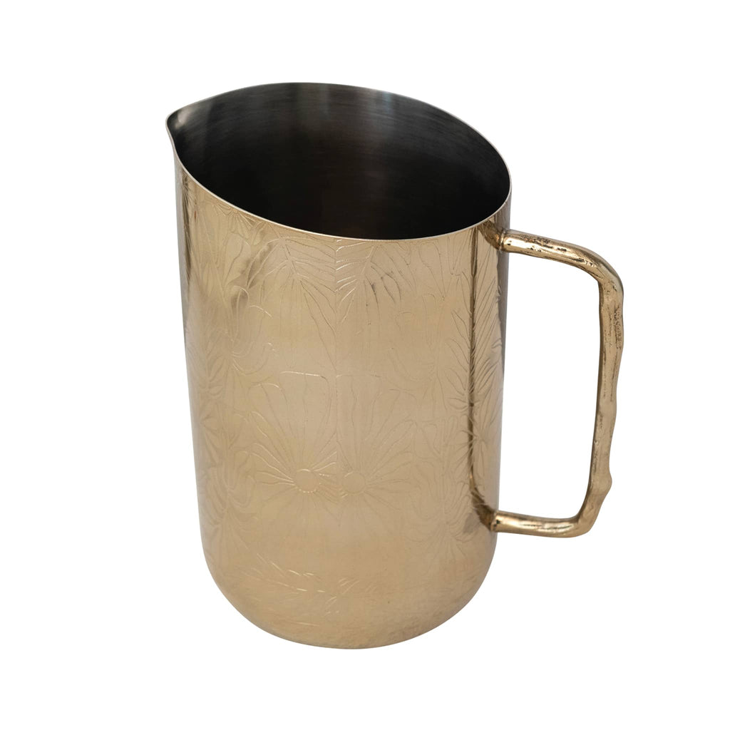 Creative Co-op Stainless Steel Pitcher with floral etched pattern and brass twig handle on the right.