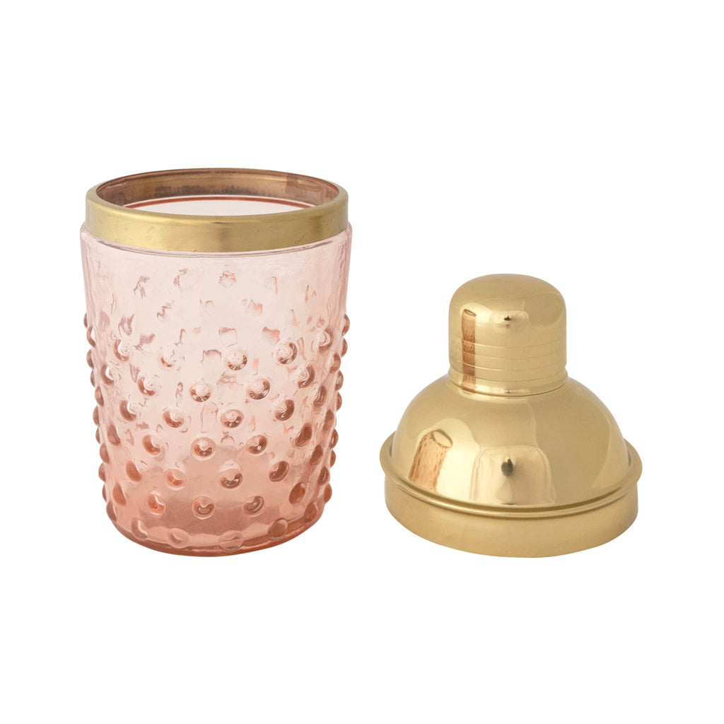 Creative Co-op pink hobnail glass and gold tone stainless steel cocktail shaker, lid off.