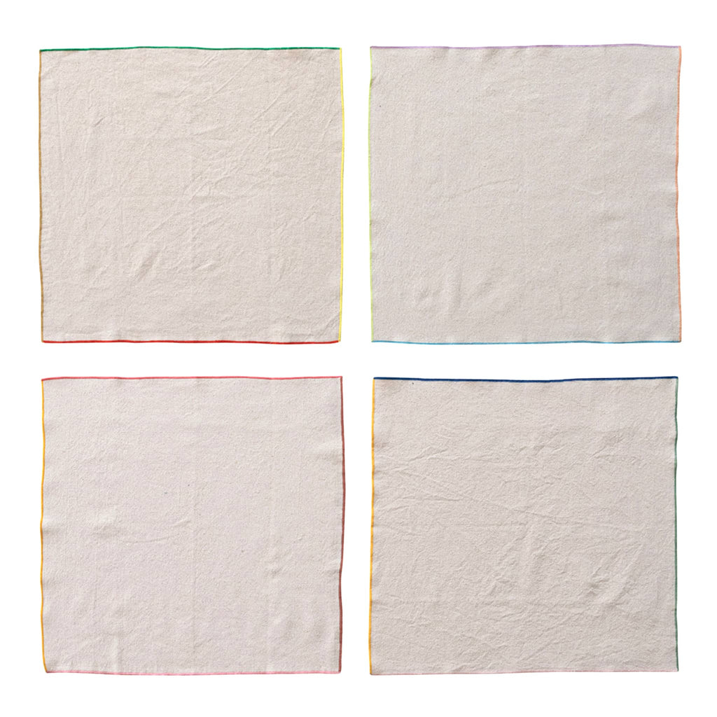 Creative Co-op square woven cotton cocktail napkins with colorful stitched edge, set of four shown flat.