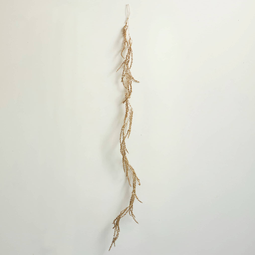 Decorative gold garland in natural light, on a white background.