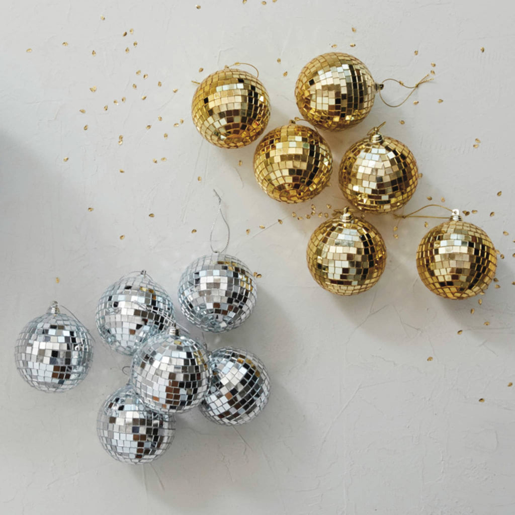 Creative Co-op 3 inch diameter glass and foam silver tone disco ball holiday ornaments, set of six in gold tone and silver tone with gold glitter.