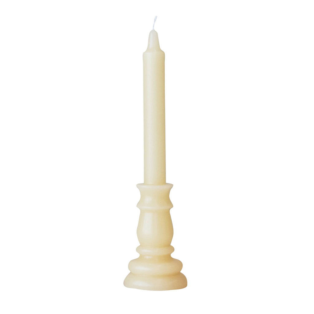 Cream colored unscented taper candle shaped to look like it's in a holder. 