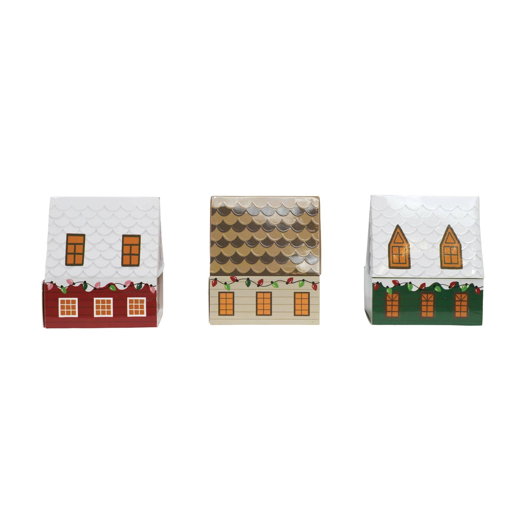Three decorative house-shaped matchboxes with different designs on a white background.