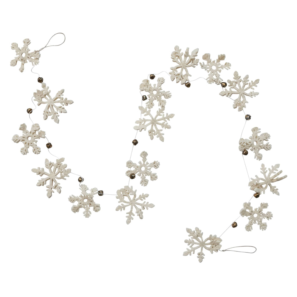 Decorative garland with felt snowflake ornaments and gold bells with hanging loops at both ends, on a white background.