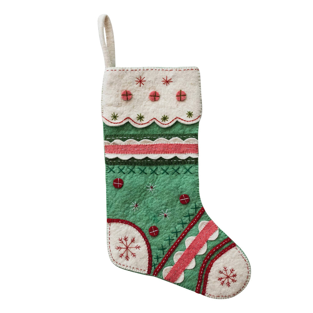 Decorative Christmas stocking with green, red, and white pattern on a white background.