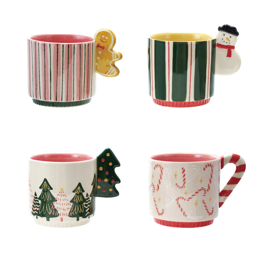 Four Christmas-themed patterned mugs with decorative shaped handles, on a white background.