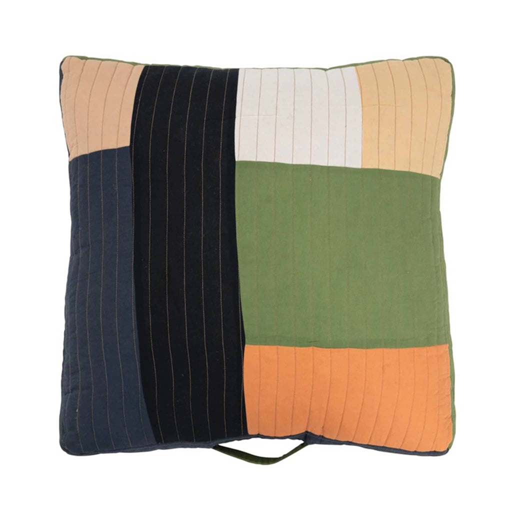 Colorful quilted patchwork floor pillow with a white background.