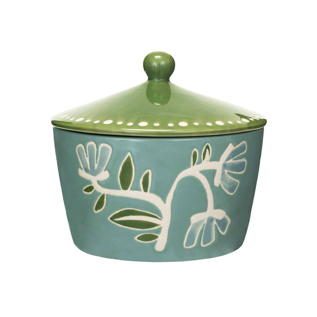 Creative Co-op hand-painted blue stoneware canister with green lid and wax relief floral print, front view.