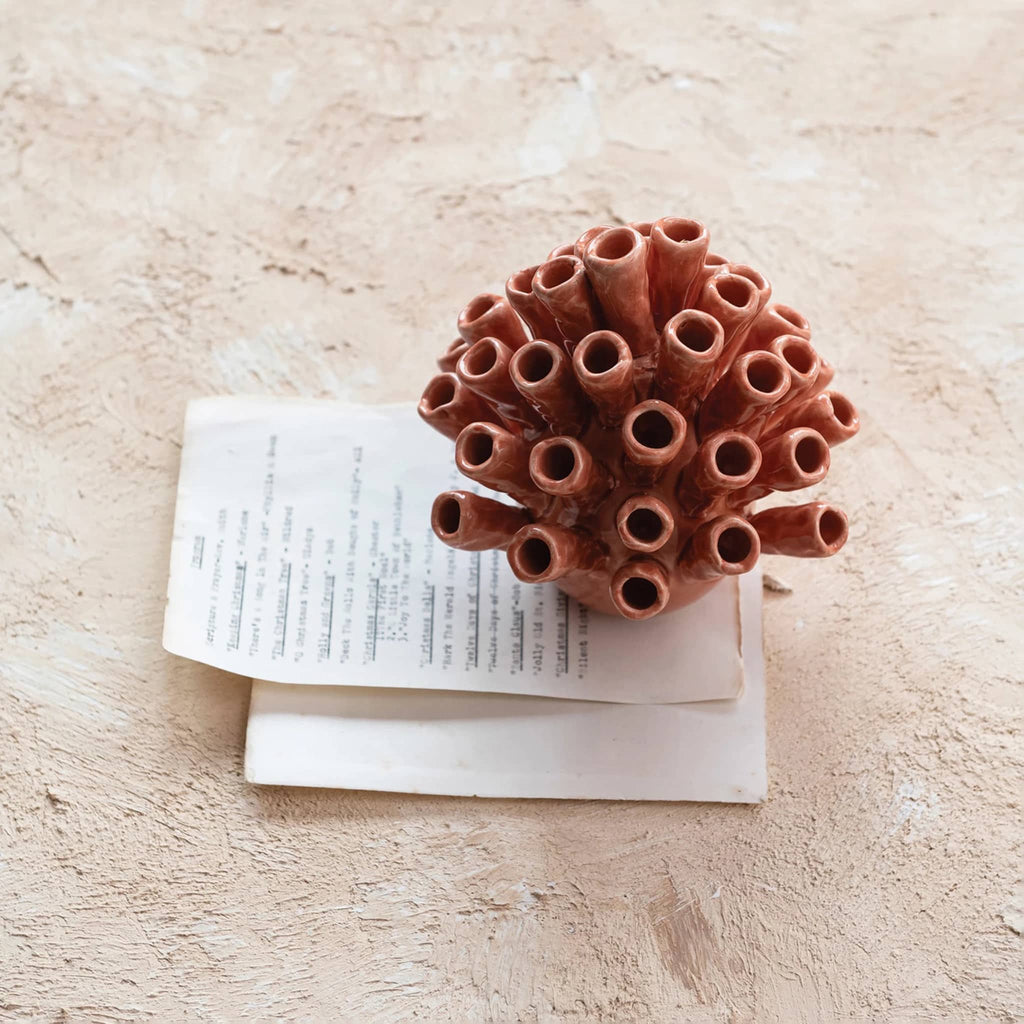 Creative Co-op Stoneware Coral Shaped Decor with crackle glaze, overhead view of vase on top of papers.