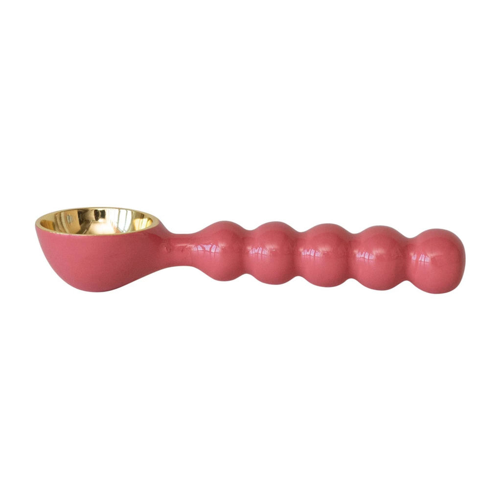 Creative Co-op Pink enameled aluminum ice cream scoop with gold bowl, side view.