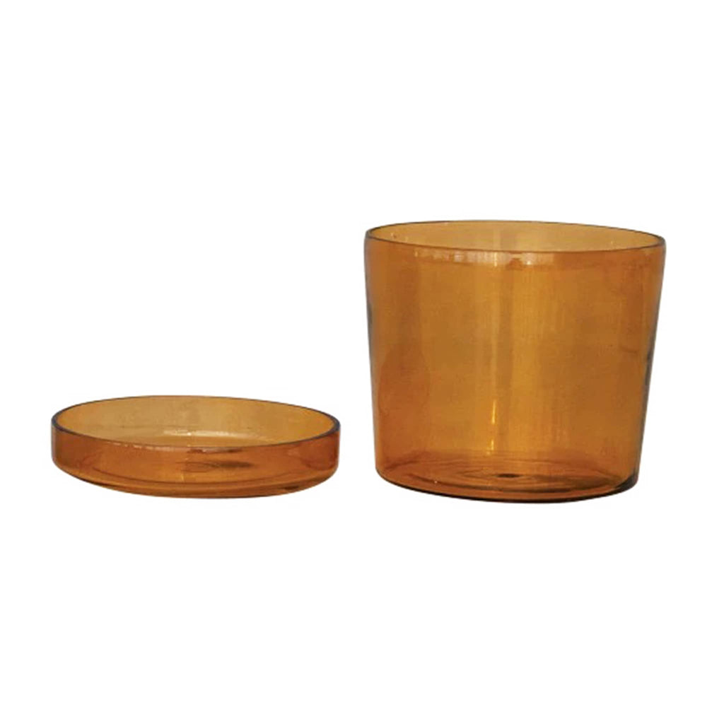 Amber glass planter with matching saucer beside it on a white background.