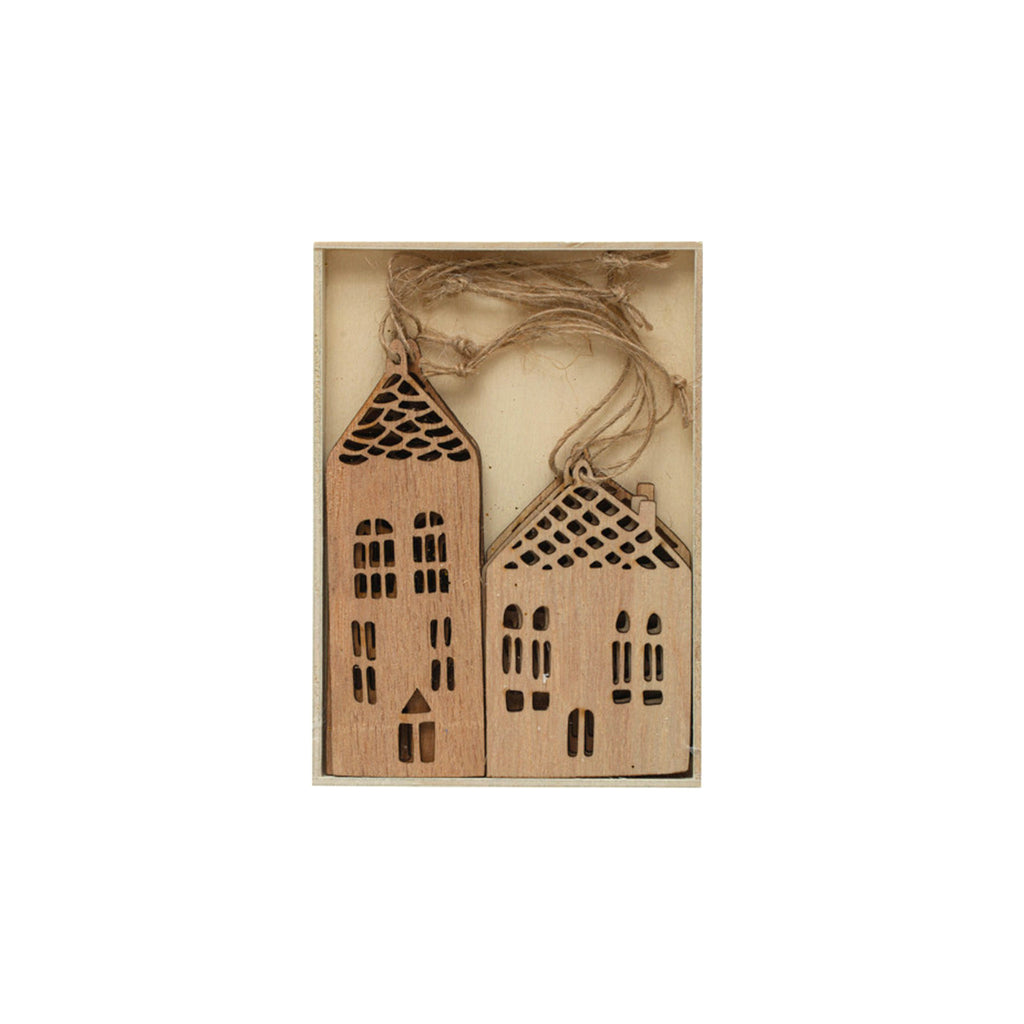 Creative Co-op set of 6 laser cut wood house ornaments with twine for hanging in brown box.